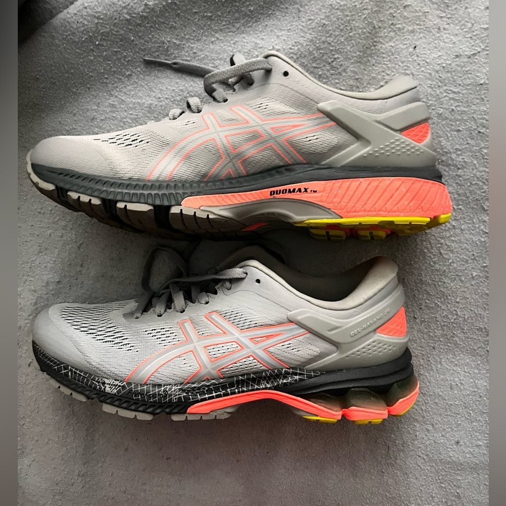 Asics running shoe, size 9.5. Color: White/grey with orange stripes.
